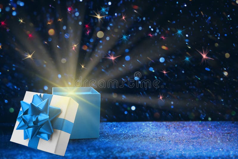 Beautiful Gift Box with Magic Light on Golden Glitters Stock Photo