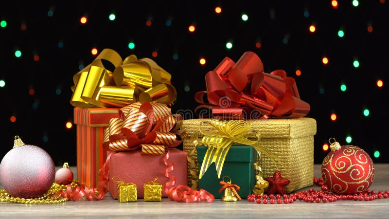 Beautiful Christmas gift boxes and decorations on a wooden floor against colorful flashing garland on black background