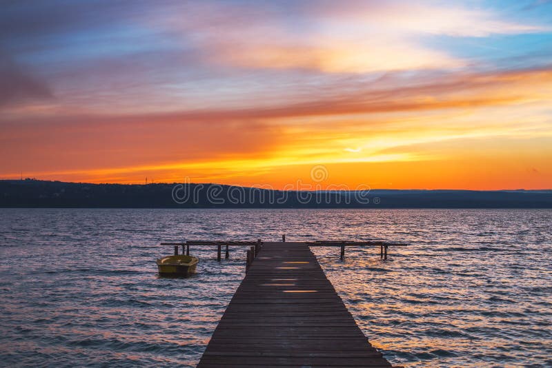 Beautiful cloudscape over the lake and blured boat stock images