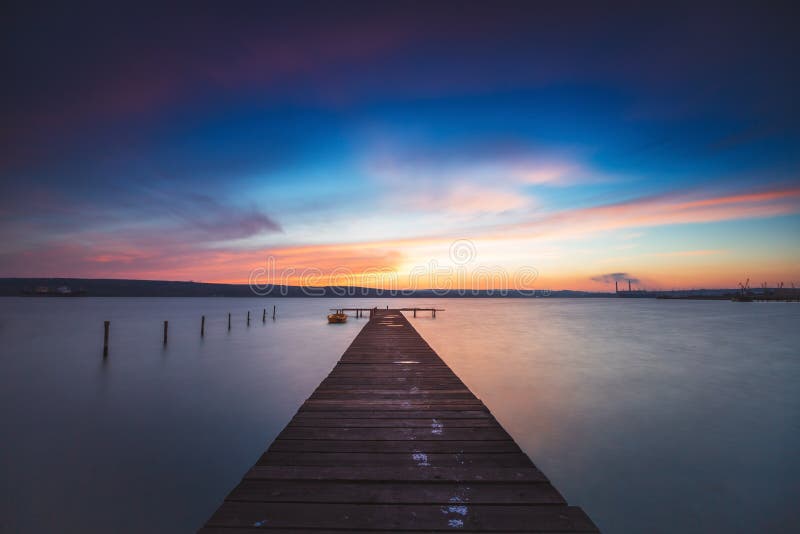 Beautiful cloudscape over the lake and blured boat stock photography