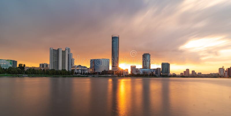 Beautiful cloudy sunset at the city pond. Cityscape of Yekaterinburg, Russia