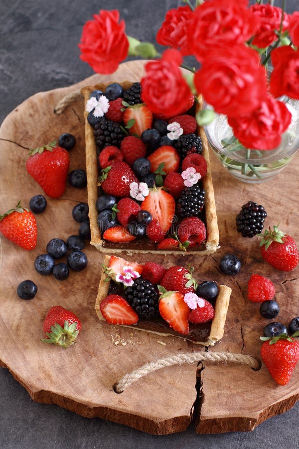 Beautiful and colorful berry fruit tart. A wholemeal tart with chocolate filling and fresh berry fruit stock photos Beautiful and colorful berry fruit tart. A wholemeal tart with chocolate filling and fresh berry fruit stock photos