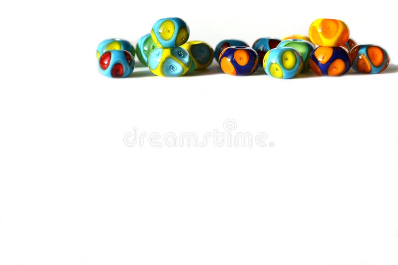 Beautiful colorful cheerful background made of handmade lampwork beads with dots.