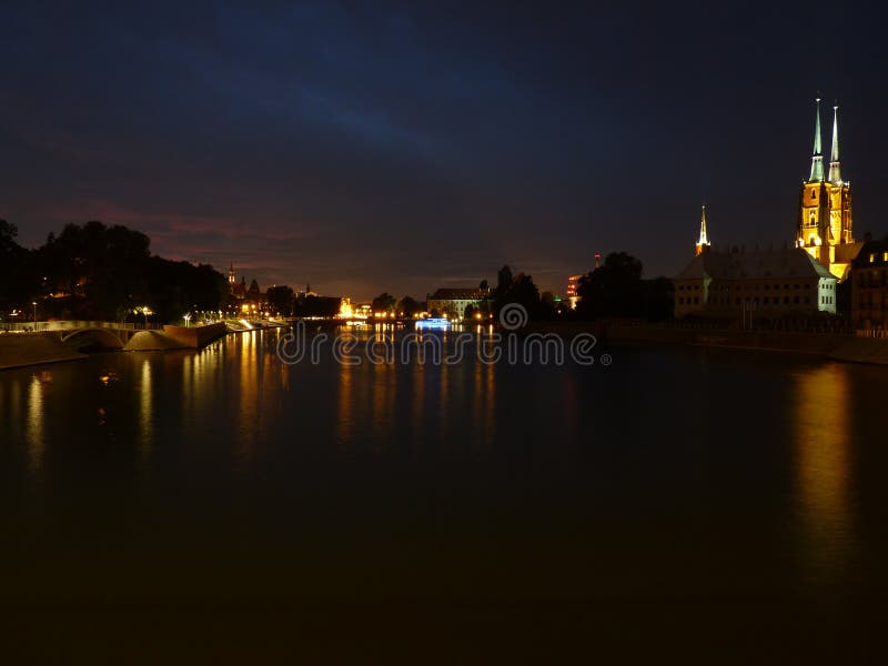 Beautiful and colorful sunset over Wroclaw. Reflection in the Odra River. Gothic cathedral of St. John the Baptist on Tumski islan stock image Beautiful and colorful sunset over Wroclaw. Reflection in the Odra River. Gothic cathedral of St. John the Baptist on Tumski islan stock image