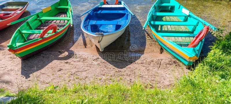 Beautiful colourful wooden boats at lake shore