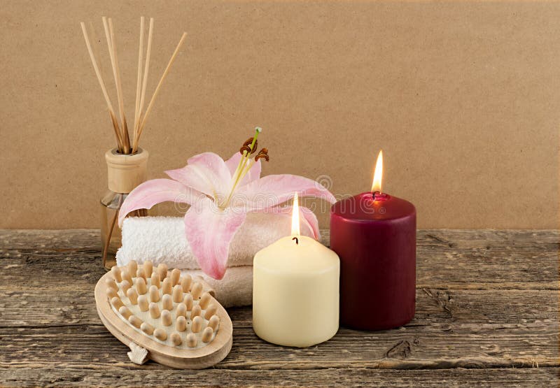 Beautiful composition with candles, spa towels and massage brush on wooden background royalty free stock images Beautiful composition with candles, spa towels and massage brush on wooden background royalty free stock images