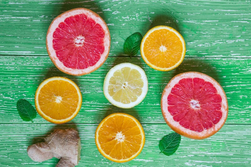 Beautiful composition of fresh orange juice in glass, lemon, ora