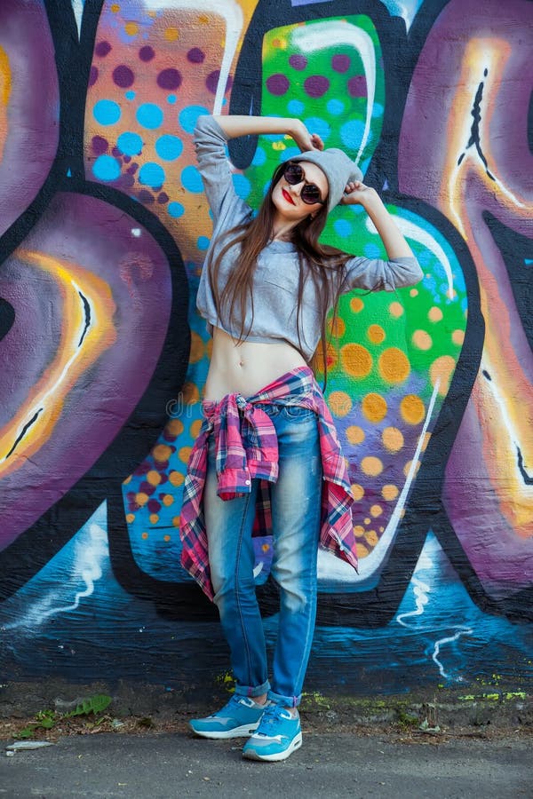 Beautiful Cool Girl in Hat and Sunglasses Over Graffiti Wall Editorial ...