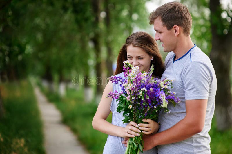 Couple with Bouquet of Flowers in the City Stock Image - Image of ...