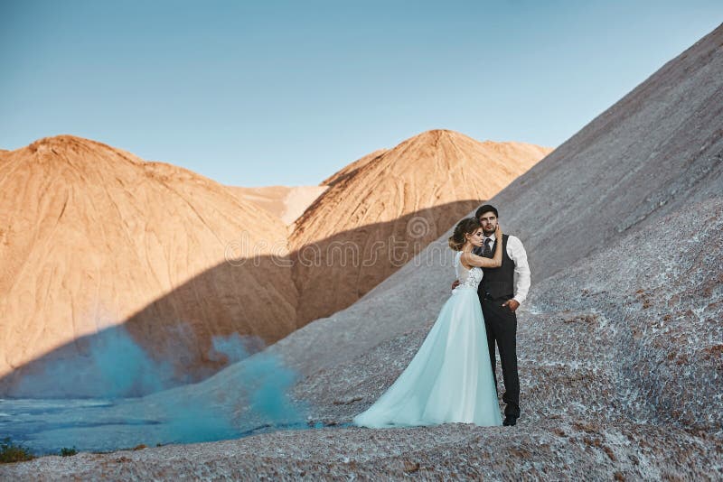A beautiful couple of lovers at a white salt desert, a young woman with a wedding hairstyle in a stylish dress and royalty free stock image A beautiful couple of lovers at a white salt desert, a young woman with a wedding hairstyle in a stylish dress and royalty free stock image
