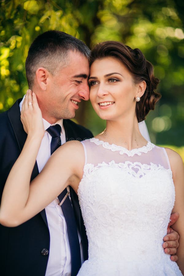 Beautiful Couple Walking in the Park in Their Wedding Day. Sunny ...