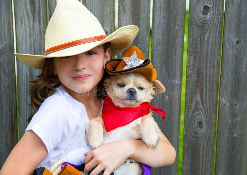 Beautiful cowboy kid girl holding chihuahua with sheriff hat royalty free stock image Beautiful cowboy kid girl holding chihuahua with sheriff hat royalty free stock image