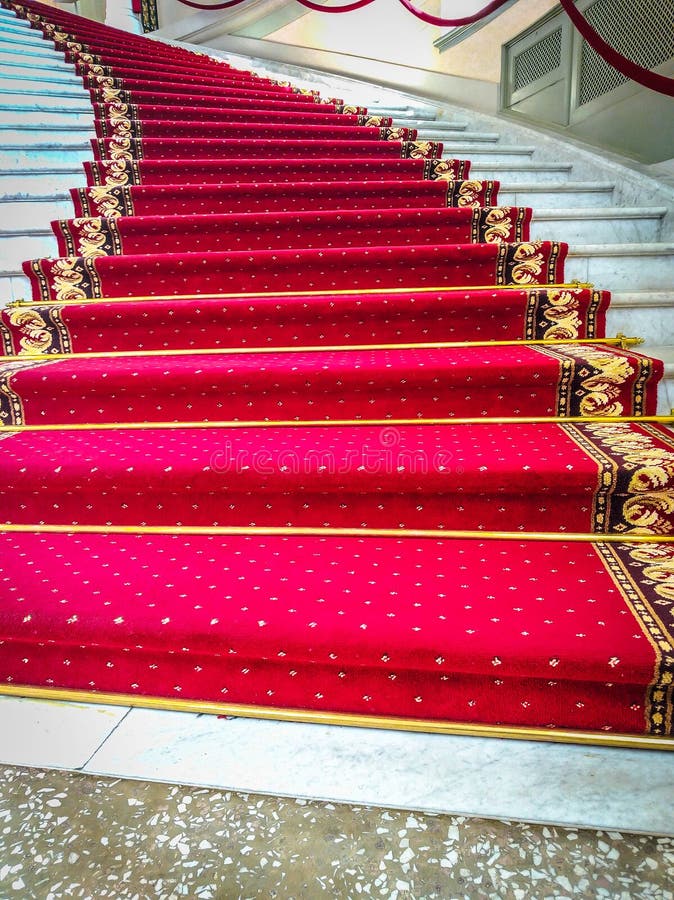 Beautiful Curved Staircase with Red Carpet for Guests Stock Image