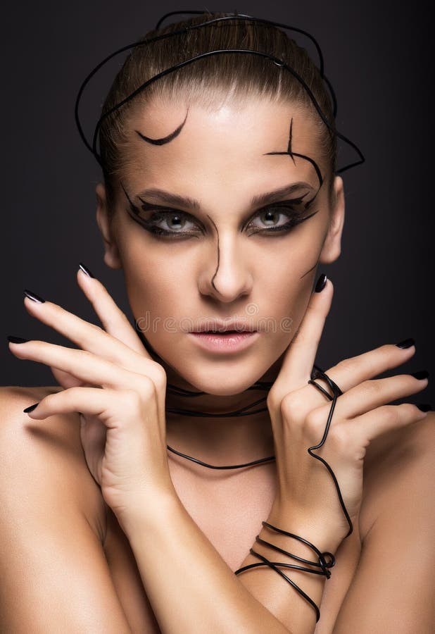 Beautiful cyber girl with linear black makeup