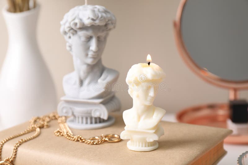 Beautiful David Bust Candles and Book on Dressing Table Stock Photo
