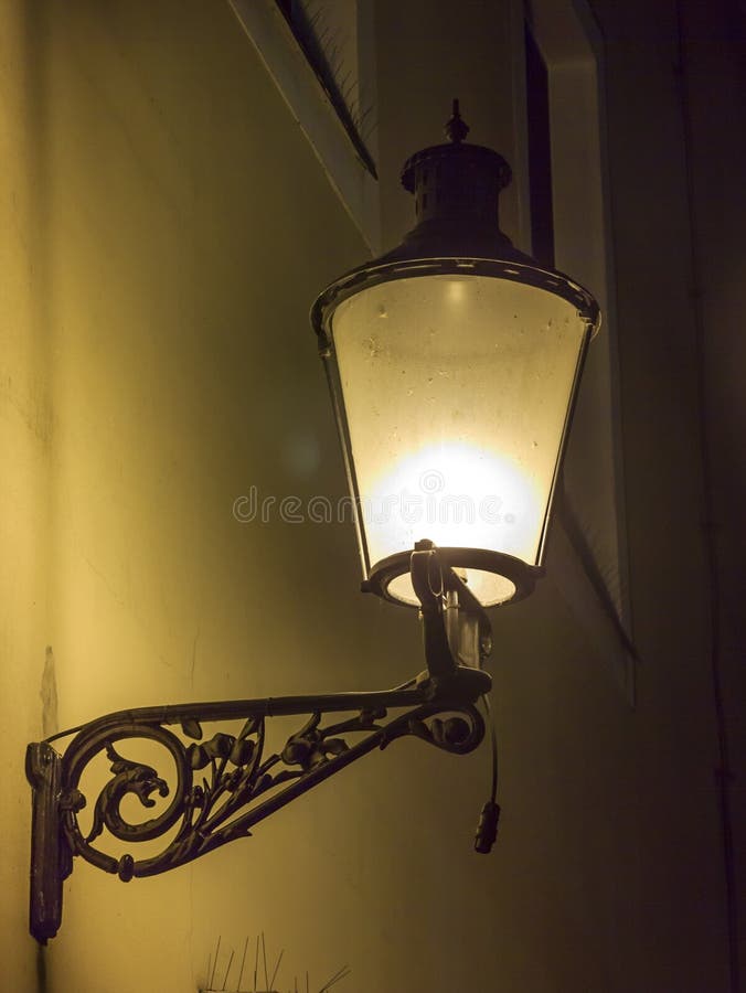 Beautiful, decorated lantern attached to the wall of an old house stock images