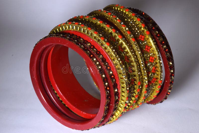 a hindu bride in red and gold clothing with red jewel bindi gold bracelet  large gold earings large gold choker stands smiling about to dance bombay  Stock Photo - Alamy