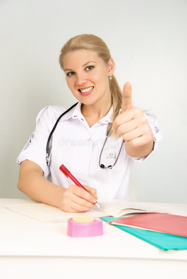 Beautiful doctor with her thumb up