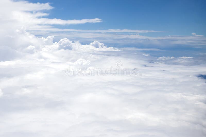 Beautiful, dramatic a group of clouds in the sky, viewed from a height from inside an airplane. Airplane height stock images, royalty-free photos and pictures