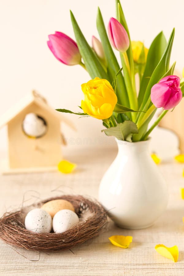 Easter decoration with spring flowers and eggs. Beautiful easter table decoration with eggs ,rabbits and flowers in pastel colors stock image Easter decoration with spring flowers and eggs. Beautiful easter table decoration with eggs ,rabbits and flowers in pastel colors stock image
