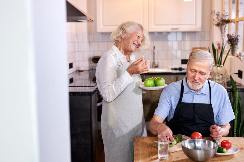 beautiful elderly couple in the kitchen at home royalty free stock image