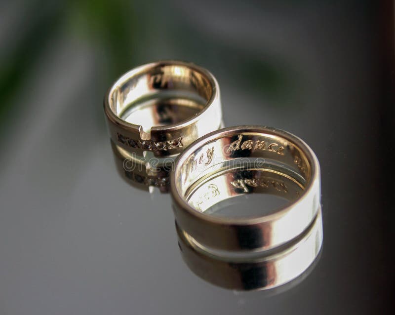 Beautiful Elegant Wedding Rings with Diamonds on a Background of Blue