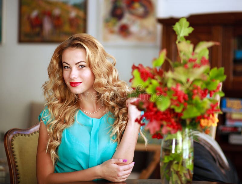 Beautiful elegant woman at home, on background of interior royalty free stock photos Beautiful elegant woman at home, on background of interior royalty free stock photos
