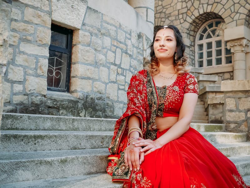 Suza poses in a traditional dress during a photoshoot