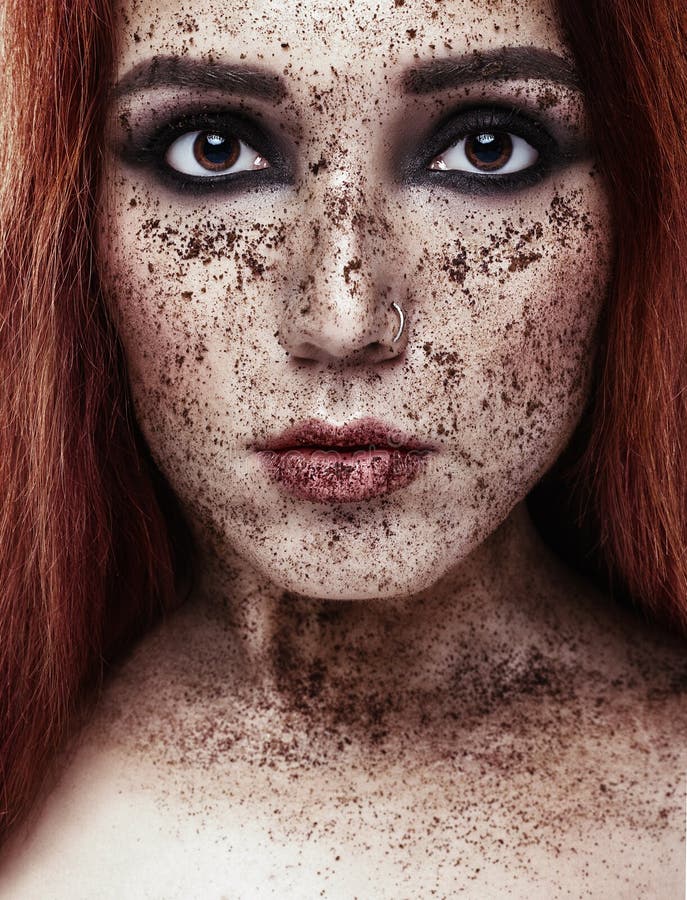 Portrait Of Young Girl With Red Hair And Ground Coffee On The Face 