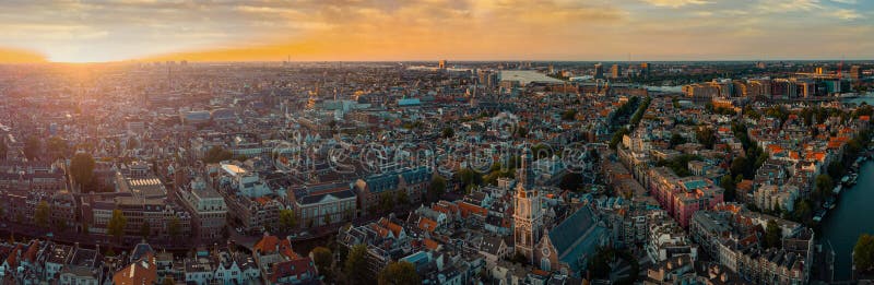 Beautiful evening panorama of Amstedam city looking towards the west with beautiful sunset and sun setting down over Amsterdam.