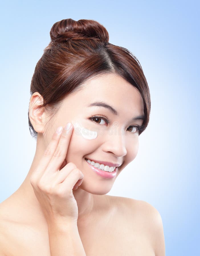 Beautiful face of girl applying moisturize cream