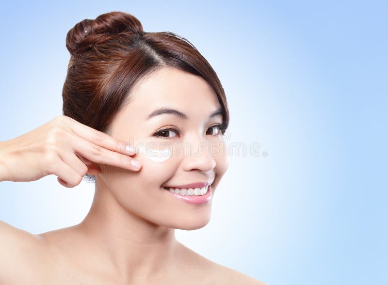 Beautiful face of girl applying moisturize cream