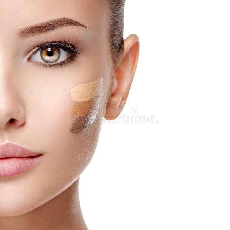 Beautiful face of  young woman with cosmetic foundation on a skin.   Beauty treatment concept. Beautiful face of  young woman with cosmetic foundation on a skin.   Beauty treatment concept