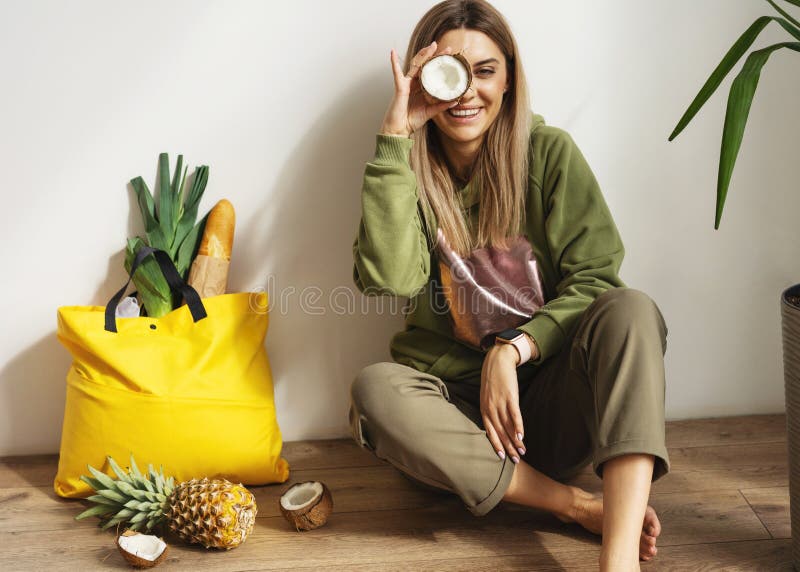 Beautiful fashion girl does shopping with herself, food delivery, take away food.  Girl sitting at home with a bag of food