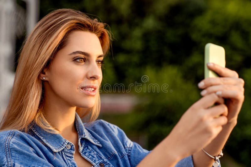 Beautiful fashion girl doing selfie with phone at sunset stock photos Beautiful fashion girl doing selfie with phone at sunset stock photos