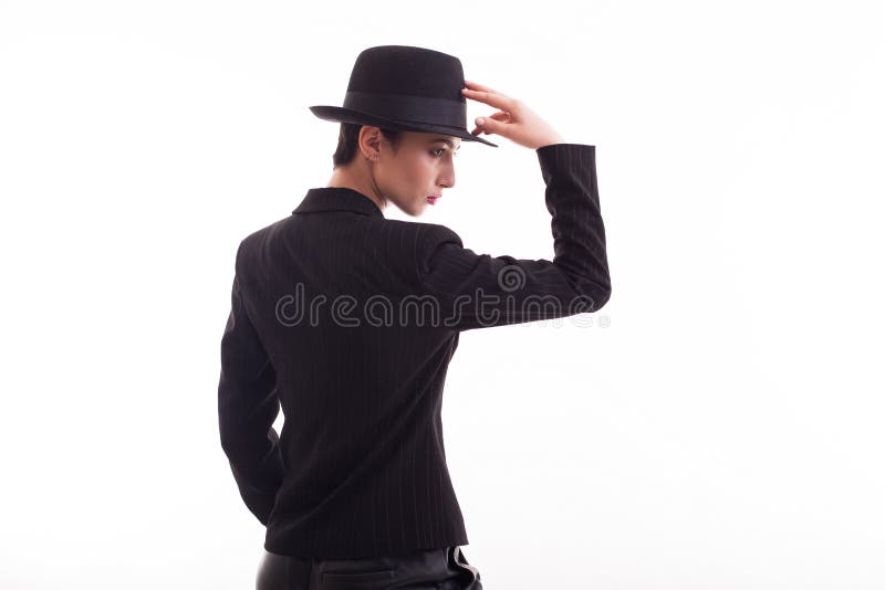 Beautiful fashion model posing in studio over white background with retro hat