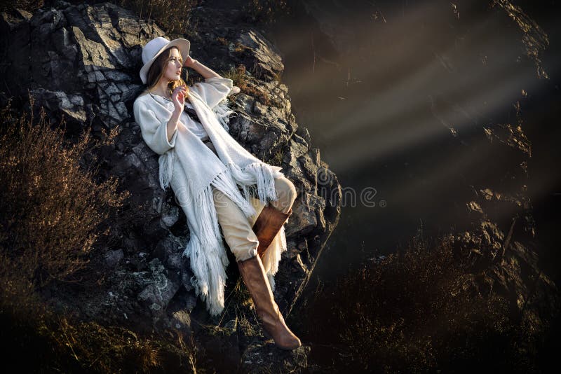 Beautiful fashion model woman posing in mountains at sunset royalty free stock photography Beautiful fashion model woman posing in mountains at sunset royalty free stock photography
