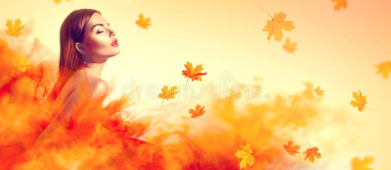 Beautiful fashion woman in autumn yellow dress with falling leaves royalty free stock image Beautiful fashion woman in autumn yellow dress with falling leaves royalty free stock image