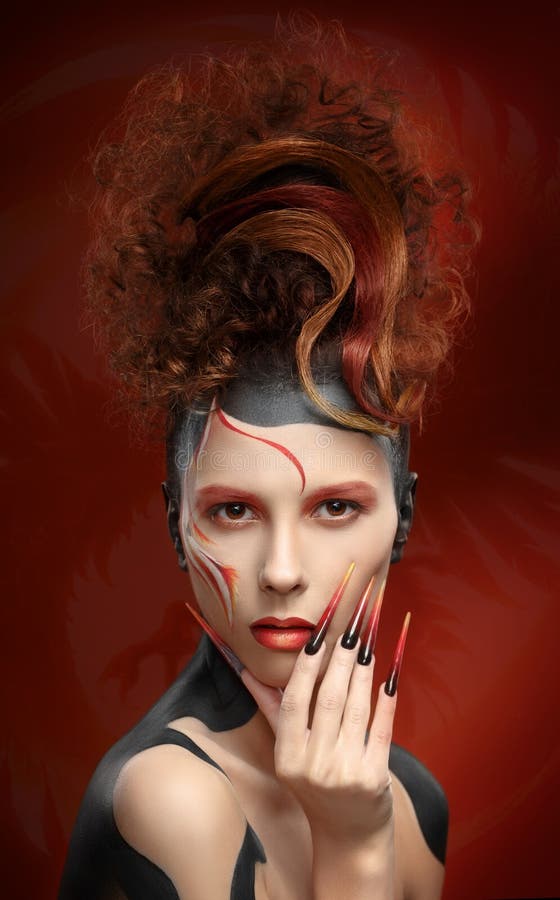 Beautiful fashion woman color face art fenix style and nail desi stock photography Beautiful fashion woman color face art fenix style and nail desi stock photography