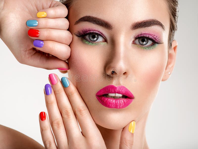 Beautiful fashion woman with a colored nails. Attractive white girl with multicolor manicure