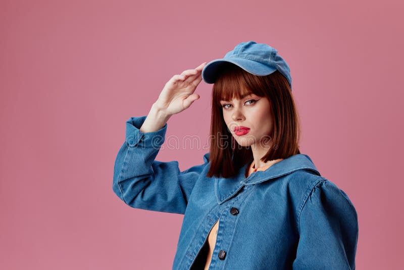 Beautiful Fashionable Girl in a Cap and Denim Jacket Posing Studio ...