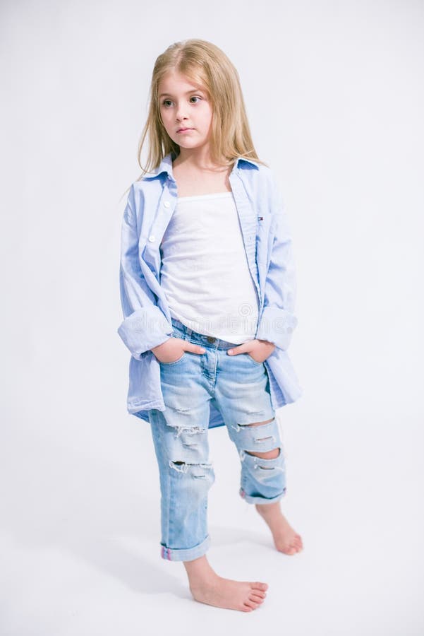 Beautiful Fashionable Little Girl with Blond Hair in Jeans Clothes on a ...