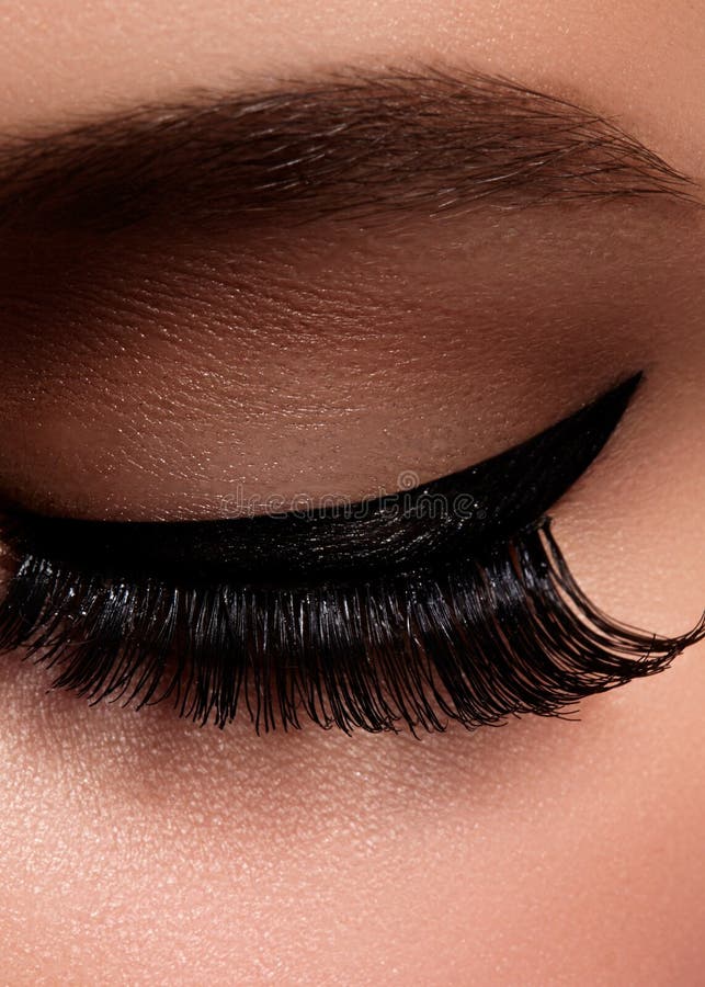 Beautiful female eye with extreme long eyelashes, black liner makeup. Perfect make-up, long lashes. Closeup fashion eyes stock photos Beautiful female eye with extreme long eyelashes, black liner makeup. Perfect make-up, long lashes. Closeup fashion eyes stock photos