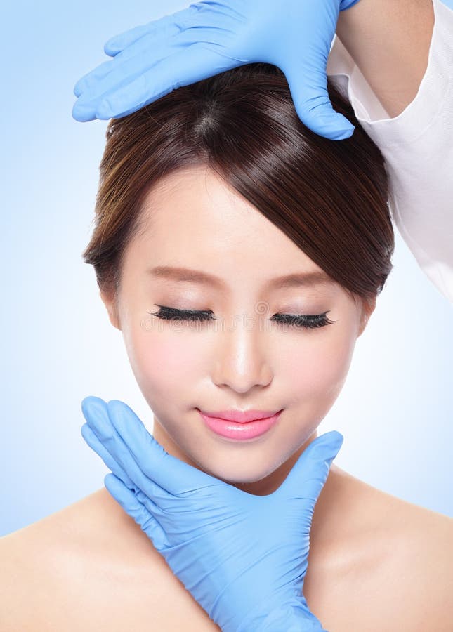 Beautiful female face with Plastic surgery glove stock image Beautiful female face with Plastic surgery glove stock image
