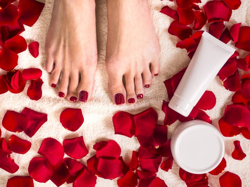 Beautiful Female Feet On Terry Towel With Rose Petals Jar And Tube Of