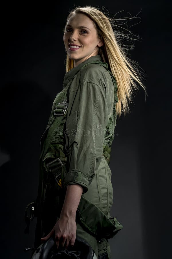 Beautiful Female Fighter Pilot Wearing a Flightsuit and Holding a Helmet in  a Studio Environment Stock Photo - Image of force, blonde: 137120106