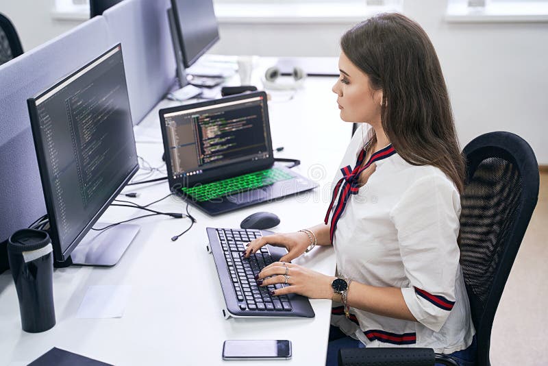 Beautiful Female Junior Software Developer Working on Computer in it