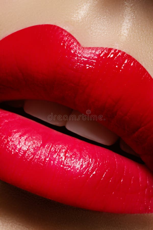 Beautiful female Lips. Sweet Kiss with red lipstick. Lip Make-up on macro shoot. Hot fashion lip makeup. Great for Valentines day