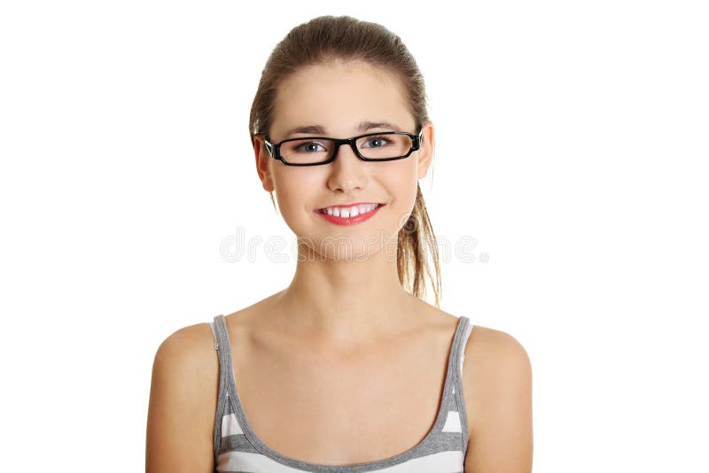 Front view face closeup of a young female caucasian teen with glasses on her face smiling to the camera, on white. Front view face closeup of a young female caucasian teen with glasses on her face smiling to the camera, on white.