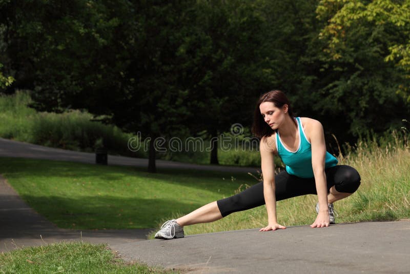 Beautiful fit athletic woman warm up stretch